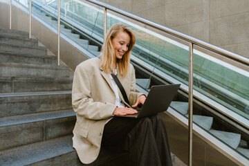 Wall Mural - Young beautiful happy smiling business lady working with laptop