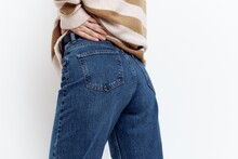 A Close-up Photo Of Stylish Jeans From Behind On A Woman Holding Her Hand Near The Pocket