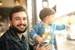 © Antonio Recena - Bearded man with baby son in bar near to window looking at camera