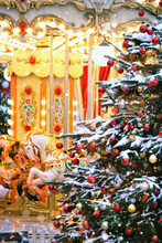 Christmas Holiday Abstract Background. Beautiful Decorated Christmas Tree And Horse Carousel On Traditional Christmas Market. Christmas And New Year Concept. Festive Winter Season.