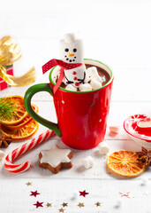 Wall Mural - Sweet Christmas homemade treats for festive party. Hot chocolate with marshmallow snowman, gingerbread, candy cane and winter spices. Concept Christmas homemade food and drink.