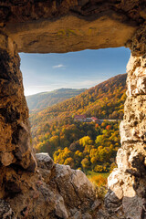 View through the window in the stone wall of the medieval Vrsatec castle. The Vrsatec National Nature Reserve in the White Carpathian Mountains, Slovakia, Europe.