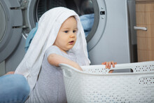 A Baby Is Inside A Laundry Basket