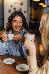 Wall Mural - Woman talks to her friend in a cafe