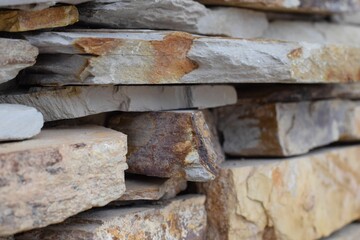 Sticker - Closeup shot of a stone wall with different textures and warm colors