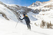 © Cavan Images - Hiker battles wind above Black Lake, Rocky Mountain National Park