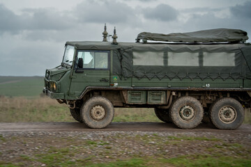 Wall Mural - A British army Steyr-Daimler-Puch - BAE Systems Pinzgauer high-mobility 6x6 6WD all-terrain utility vehicle on a military battle exercise, Wilts UK