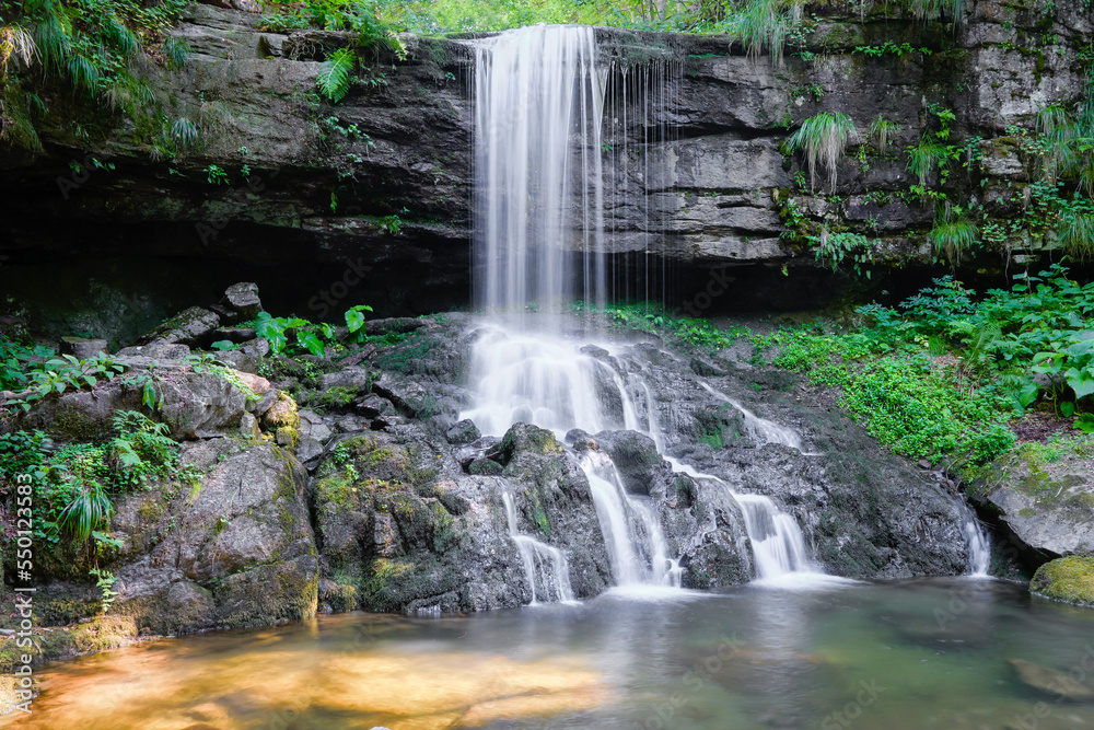 Beautiful waterfall during spring with silver colored water, cascading ...