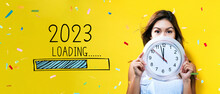 Loading New Year 2023 With Young Woman Holding A Clock Showing Nearly 12