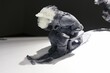 Closeup of an abstract design of jade carved stone age man sledging on the snow