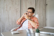 © Miljan Živković - one caucasian man making a phone call at work in the office sitting