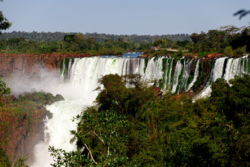 Wall Mural - Tourists walk across a platform at Iguazú Falls