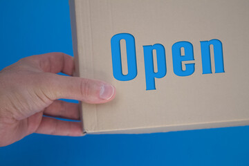 Poster - Open word with cardboard box. Brown folded card box.