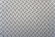 A metal background with a tread plate pattern