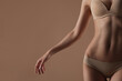 © Mirrorstudio - Thin young woman in underwear on beige background