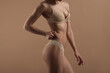 © Mirrorstudio - Thin young woman in underwear on beige background