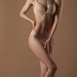 © Mirrorstudio - Thin young woman in underwear on beige background