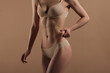 © Mirrorstudio - Thin young woman in underwear on beige background