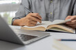 © khunkornStudio - learning online class by using laptop computer and writing notebook at workplace, Education development or knowledge improvement concept.