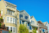 Fototapeta  - Row of houses in historic districts in San Francisco California in midday sun with clear blue sky background
