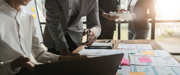 Wall Mural - Business people are meeting for analysis data figures to plan business strategies. Business discussing concept.