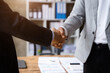 © NINENII - Close up two men shake hands at business meeting, office negotiations. Making deal sign, conclude contract.
