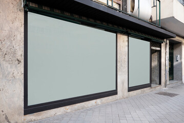 Wall Mural - Front of a commercial premises with two white glass windows and faded marble walls and black painted steel edges and street are conventional flooring