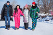 © Andrey_Arkusha - Young family of four walking outdoors in winter