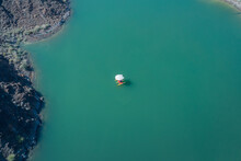 Aerial View Of Kayakers Under Parasol In Blue Mountain Lake Water In Hatta, Dubai