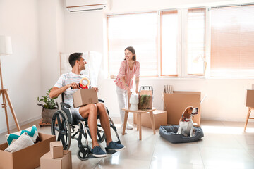 Sticker - Young woman with her husband in wheelchair and dog packing things in room on moving day