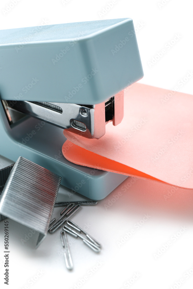 Stapler with sticky notes and staples on white background, closeup
