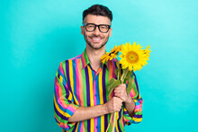Photo Of Positive Nice Person Beaming Smile Hands Hold Bunch Sunflowers Isolated On Aquamarine Color Background