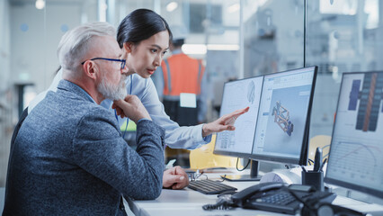 Wall Mural - Factory Office Facility: Industrial Engineers Drafting Blueprints of a Heavy Industry Machine Parts on a Computer CAD Software. Asian Female Technician Discusses Work with Middle Aged Designer.