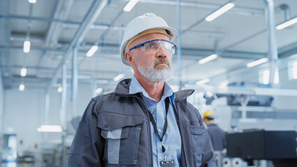 Poster - Close Up Portrait of a Middle Aged, Successful Male Engineer in White Hard Hat and Safety Glasses, Standing at Electronics Manufacturing Factory. Heavy Industry Professional Posing for Camera.