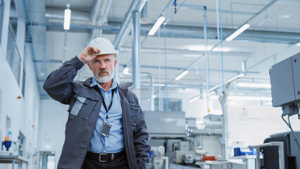 Poster - Portrait of a Middle Aged, Successful Male Engineer Putting On a White Hard Hat a, While Walking at Electronics Manufacturing Factory. Heavy Industry Specialist Starting a Work Day.