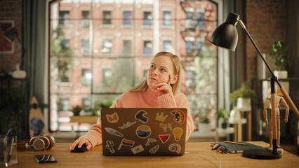Poster - Creative Young Woman Sitting at a Desk at Home Office Studio, Working on Laptop Computer. Specialist Thinking About a Business Proposition to Client. Problem Solving Concept.