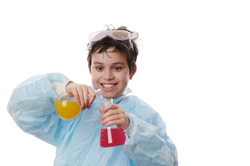 Chemistry lesson. Isolated portrait on white background of a smart preteen child boy, a chemist scientist wearing blue medical gown, doing experiment with chemical fluids at chemistry class. Ad space