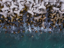 Aerial Drone View Of A Breakwater. Breakwater In The Sea, A Collection Of Concrete Breakers