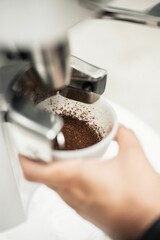 Canvas Print - Vertical shot of a process of making an expresso coffee with hands and equipment