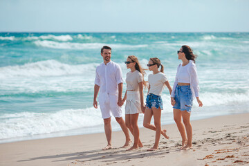 Wall Mural - Happy family on the beach during summer vacation