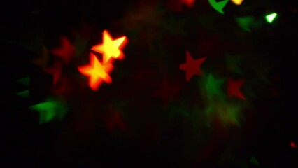 Wall Mural - a moving 4k background of twinkling christmas stars. shimmering iridescent christmas stars bokeh on 