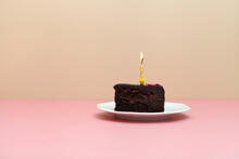 Chocolate Slice Cake With Candle On Pink Background-happy Birthday Tart -minimalistic Image