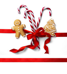 Wall Mural - christmas composition with isolated christmas sweet candy, ginger men and red silk ribbon on transpa