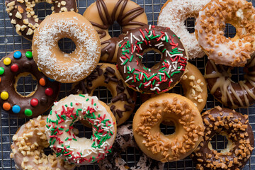 A pile of delicious homemade donuts with various glazes and toppings.