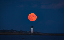 A Full Hunter Moon Rises Over The Fayerweather Lighthouse In Bridgeport Harbor, Long Island Sound, Connecticut.