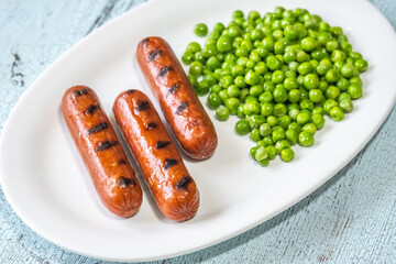 Canvas Print - Grilled sausages with green peas