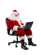 © alphaspirit - santa claus works with his laptop for christmas