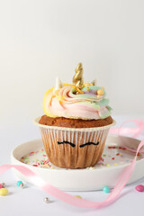 Cute sweet unicorn cupcake on white background