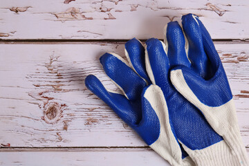 Gardening gloves on white wooden table, top view. Space for text