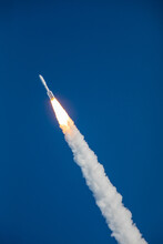 A Rocket Blasting Off And Soaring Into Space In The Sky Going Upward After Lifting Off From Launch Pad. Digitally Enhanced. The Elements Of This Image Furnished By NASA.